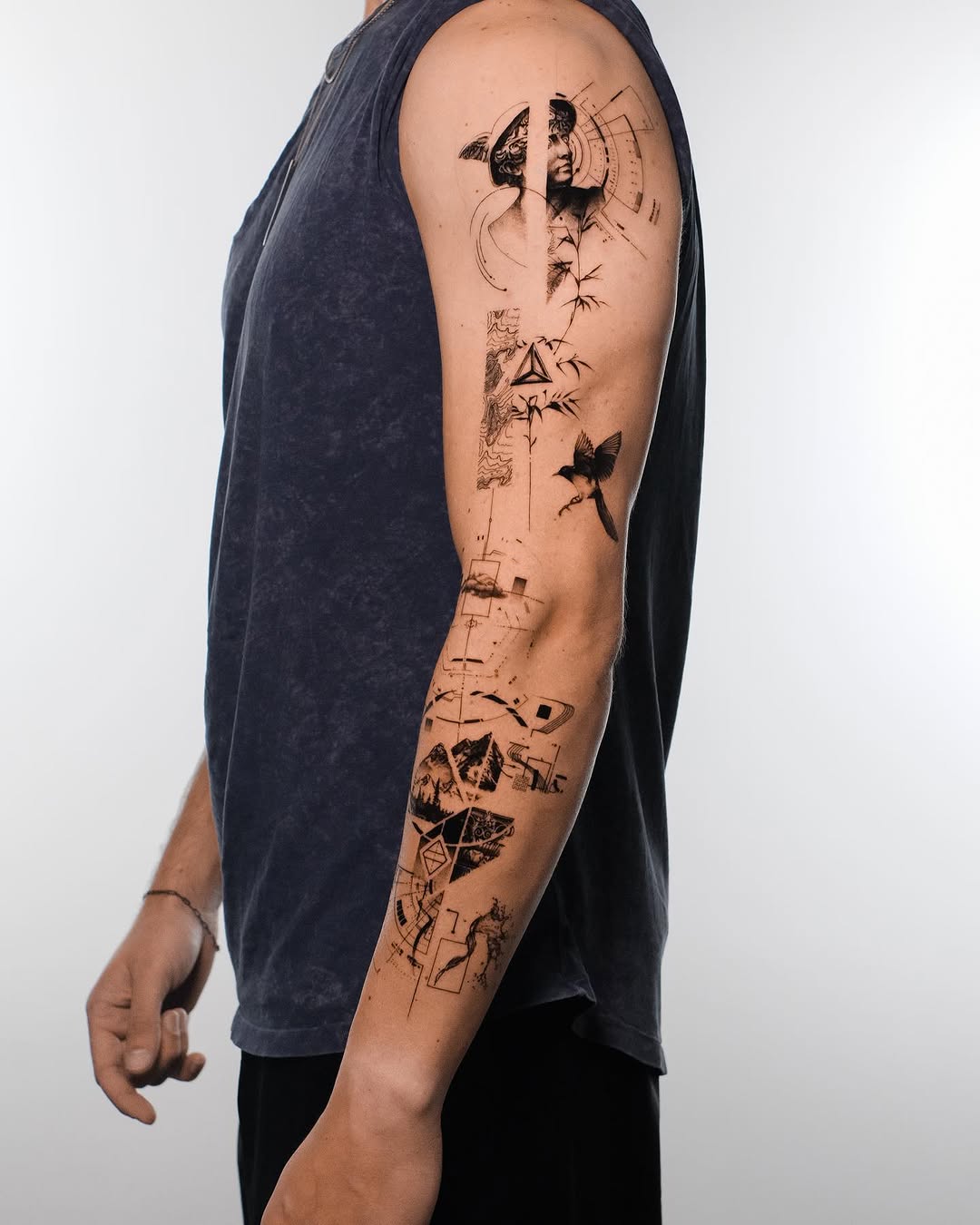 Full sleeve in progress with statue, bird and geometry