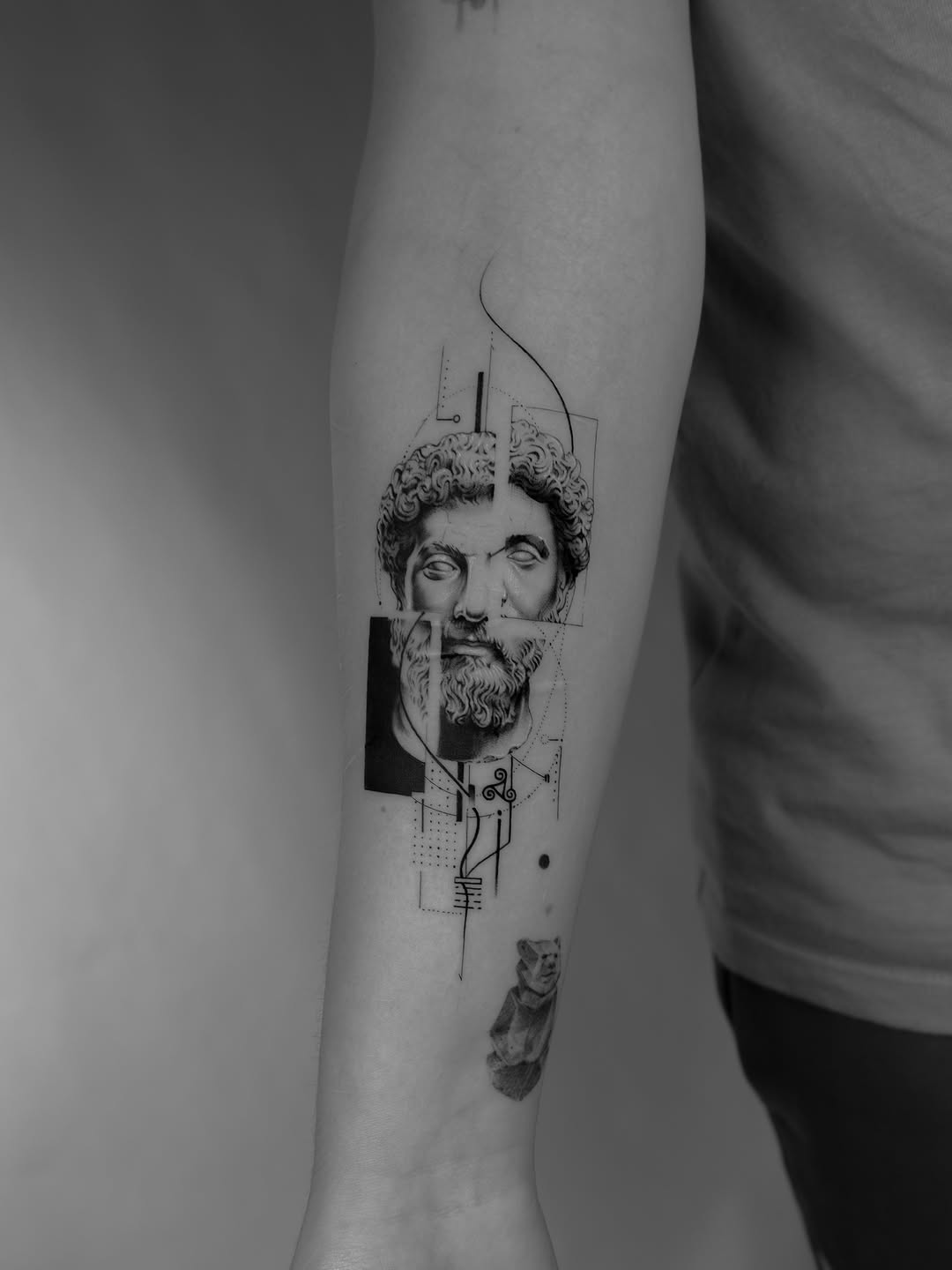 Marcus Aurelius portrait with geometric collage on a forearm
